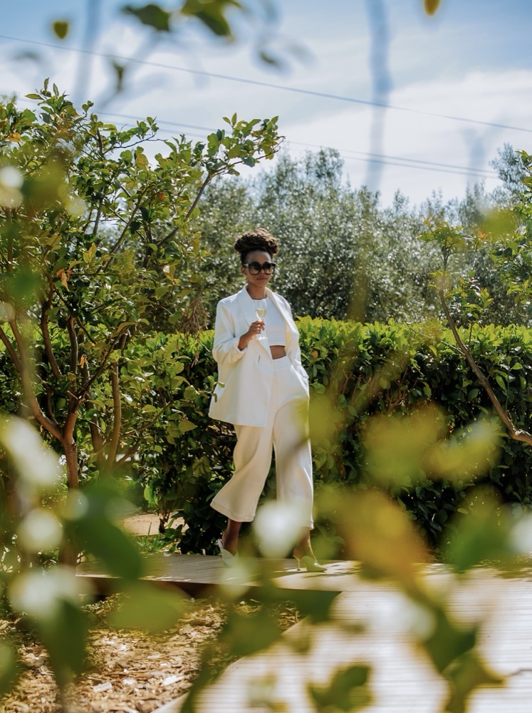 A guest raises a glass among Olijvenkraal's olive groves