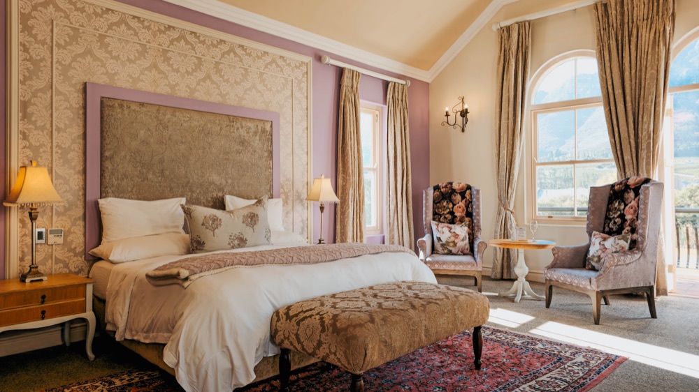 A suite bedroom at L'Ermitage Franschhoek Chateau & Villas