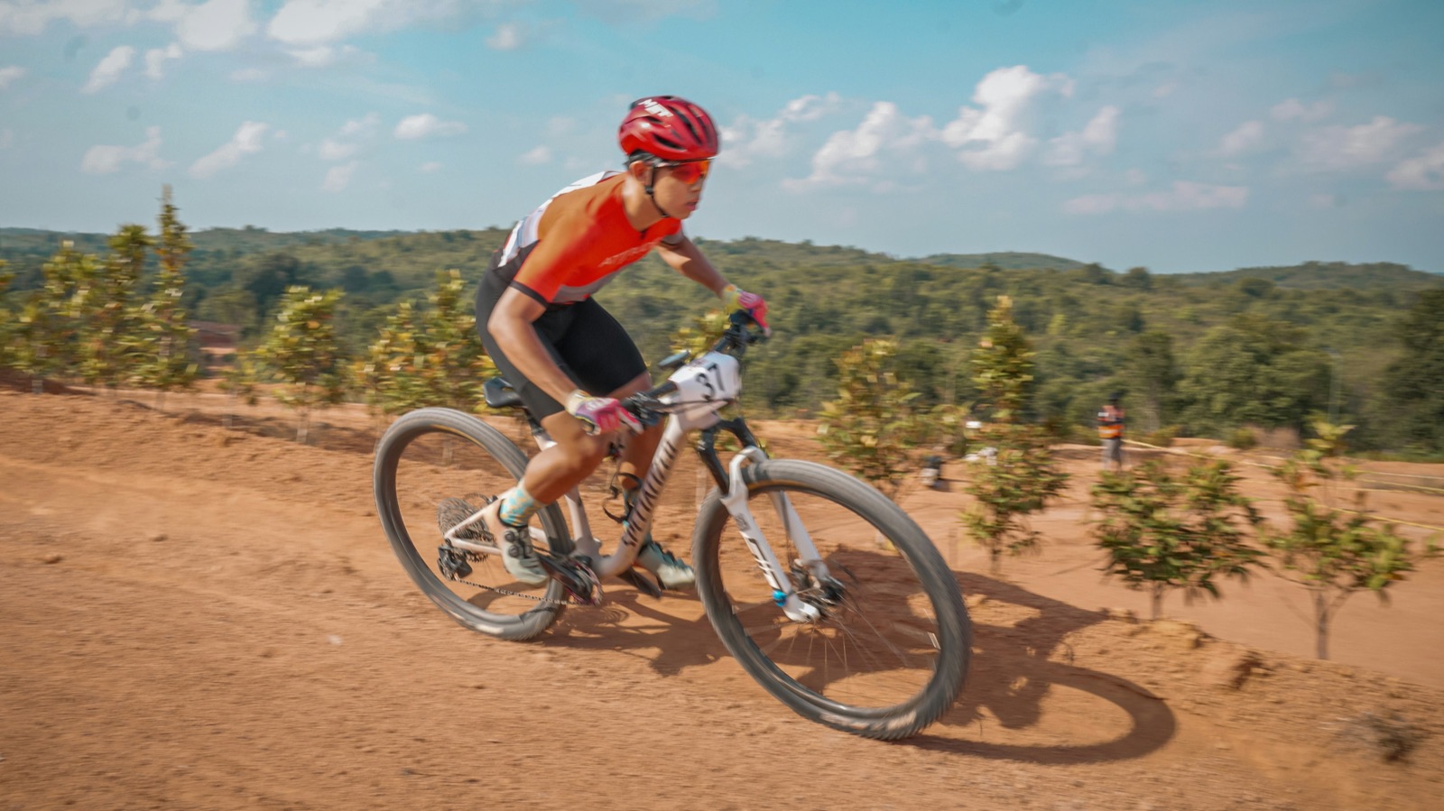 A mountain biker racing on a dirt trail (illustrative photo, not the Stellenbosch route)