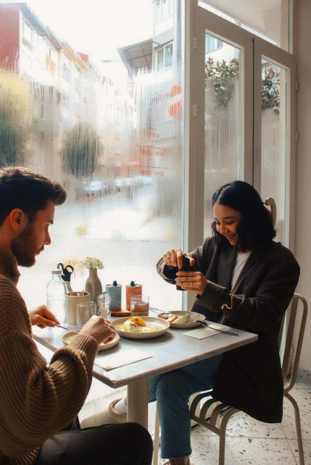 Friends sharing breakfast at a cafe table (illustrative photo, not The Meeting Place)