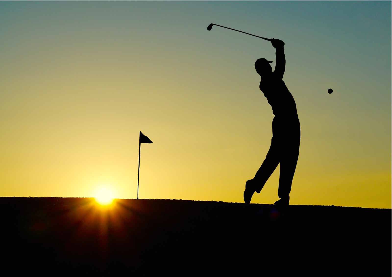 A golfer silhouetted against the sunset (illustrative photo, not Stellenbosch Golf Club or a tournament photo)
